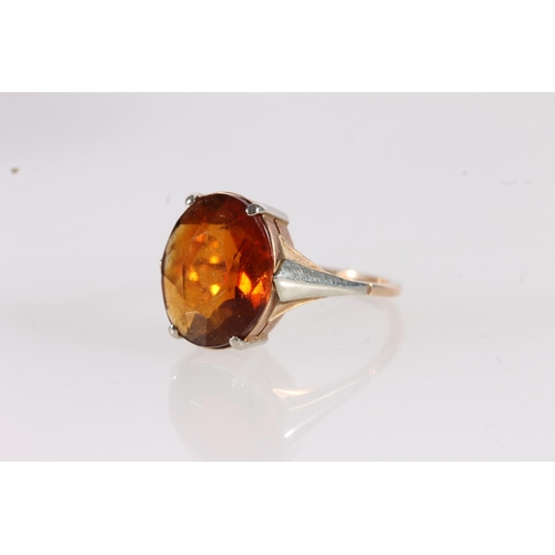 526 - Yellow and white metal ring, the inside faintly marked '9', set with oval orange citrine, size I/J.&... 