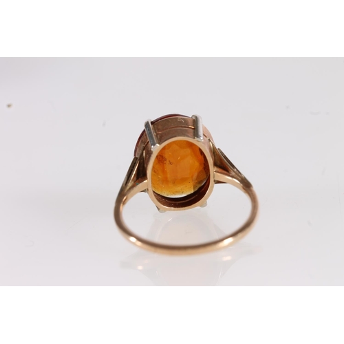 526 - Yellow and white metal ring, the inside faintly marked '9', set with oval orange citrine, size I/J.&... 