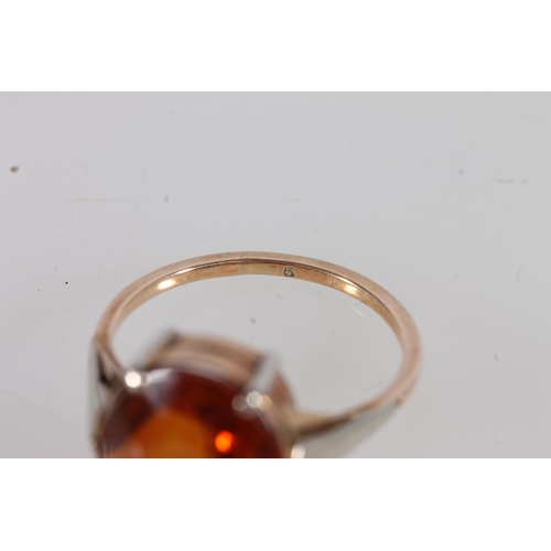 526 - Yellow and white metal ring, the inside faintly marked '9', set with oval orange citrine, size I/J.&... 