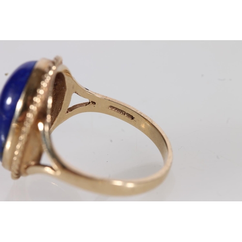 528 - 9ct gold ring set with oval lapis lazuli cabochon stone, together with a pair of conforming 14ct gol... 