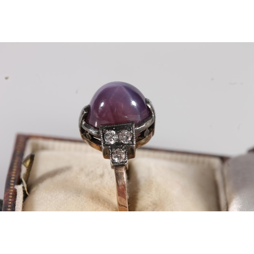 530 - Early 20thC star ruby and diamond ring, the cabochon Burmese or Ceylon ruby flanked by six round cut... 