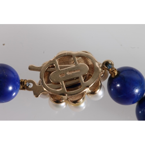 545 - Lapis Lazuli bead necklace with small pearl and 9ct gold clasp, total L46cm.