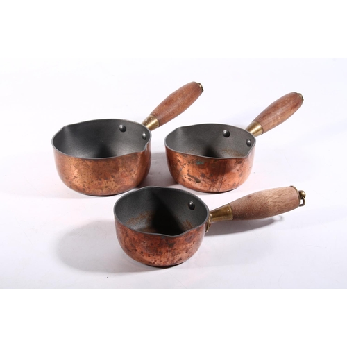 47 - Three graduated copper pans, largest 24cm long.