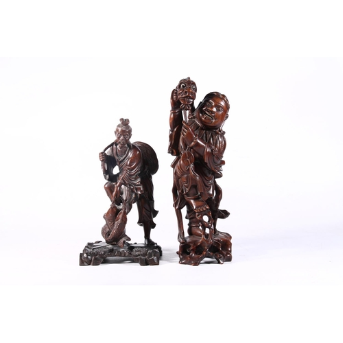 102 - Two early 20th century Chinese hardwood carved figurines, 36cm high.