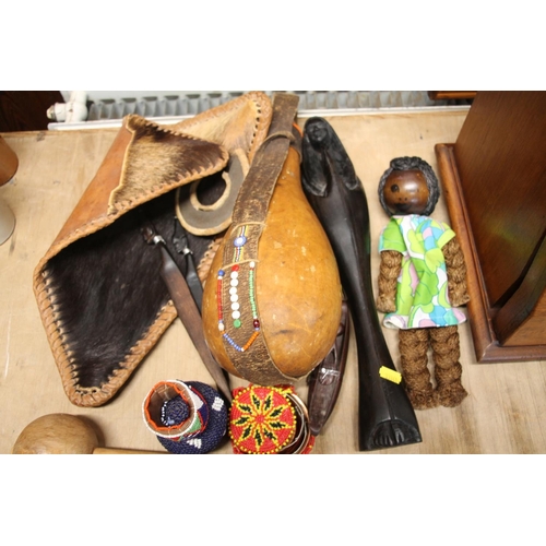 158 - African knobkerrie, an African wooden stick, an African gourd water bottle, carved African items, et... 