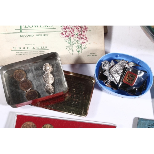 241 - Wooden painted fruit bowl, coins, cigarette cards, vintage badges and a bone needle case.