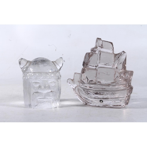 255 - Scandinavian Pukeberg Glass ship paperweight and a similar glass Viking head paperweight.