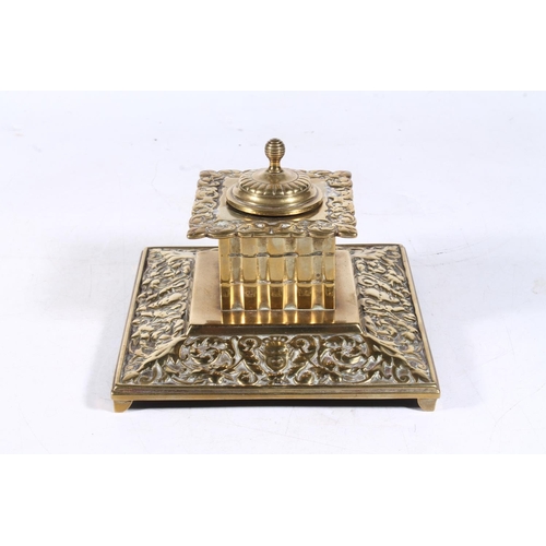 266 - Early 20th century brass inkwell of embossed baroque design, 15cm wide.