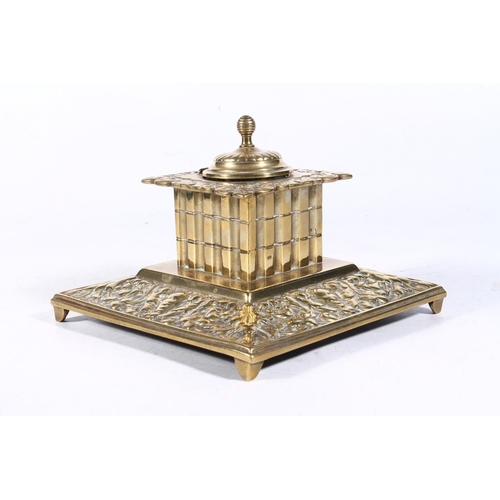 266 - Early 20th century brass inkwell of embossed baroque design, 15cm wide.