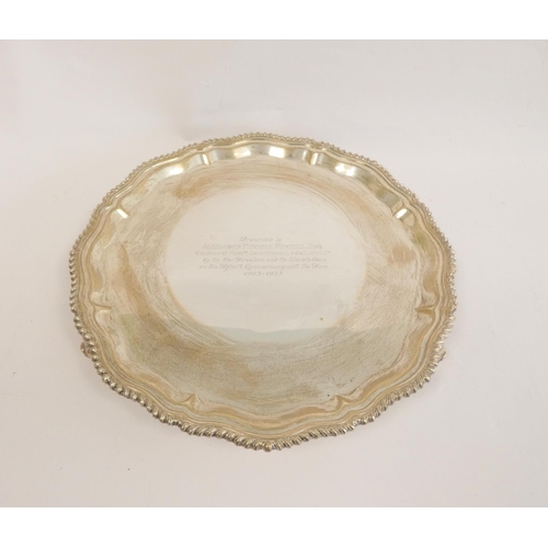 105 - Silver circular tray with shaped moulded gadrooned border on scroll feet, by Hamilton & Inches, ... 