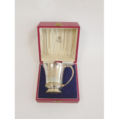 111 - Silver mug and napkin ring with celtic bands, 1953, cased 184g