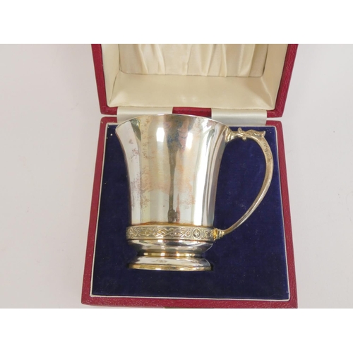 111 - Silver mug and napkin ring with celtic bands, 1953, cased 184g