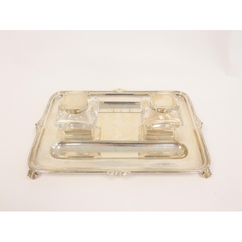 99 - Silver inkstand, rectangular with moulded and scroll edges, two mounted glass receivers (one cap det... 