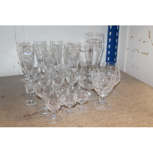 324 - Glassware to include cut glass champagne flutes and others.