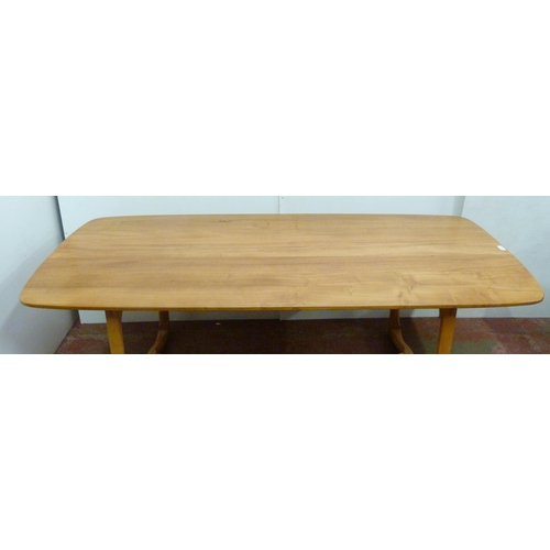 506 - Ercol beech and elm refectory table with ornate shaped supports to each end, united by beam stretche... 