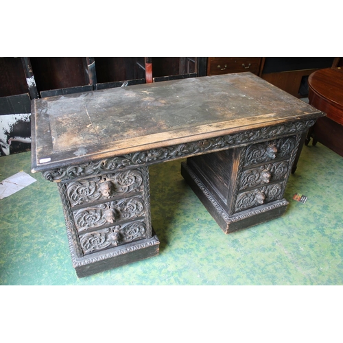 642 - Heavily carved Victorian oak pedestal desk, 138cm wide.