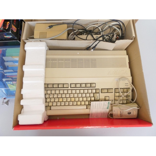 107 - A boxed Commodore Amiga 500 console together with a selection of games to include A320 Airbus flight... 