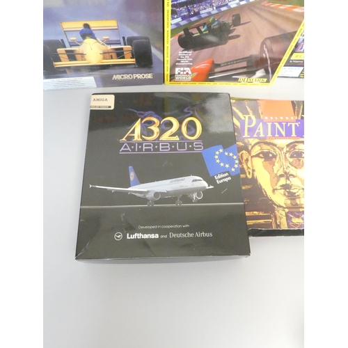 107 - A boxed Commodore Amiga 500 console together with a selection of games to include A320 Airbus flight... 