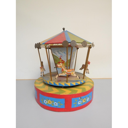 114 - Vintage scratch built wooden carousel in bright polychrome painted finish, the canopy with applied B... 