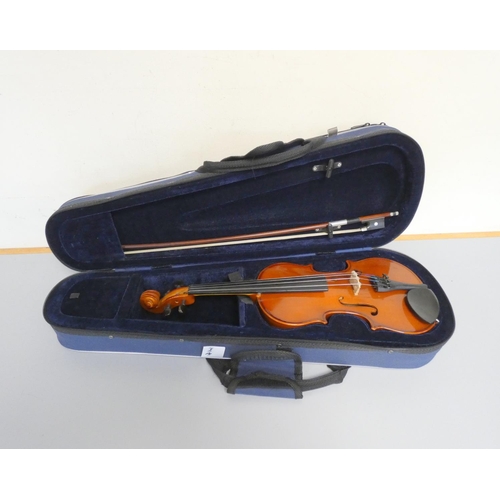 424 - 1/4 scale violin by Primavera, spruce top with two piece maple back. With case and bow.