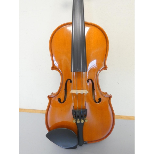 425 - 1/8 scale student violin by Stentor, spruce top with two piece maple back. With case and bow.