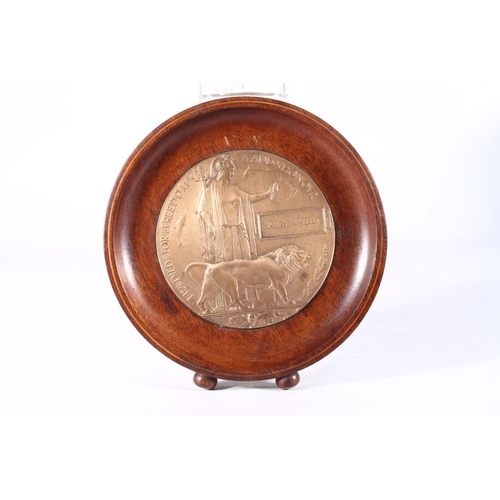 1187 - Medal of James Walker comprising WWI death plaque [JAMES WALKER] inset into circular mahogany frame.