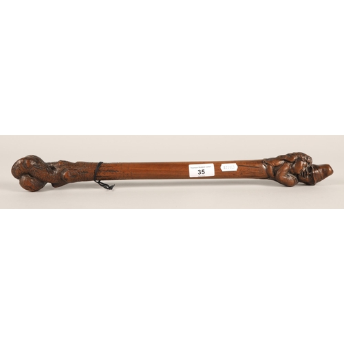 35 - Double ended carved wooden stick with couple embracing at one end, 50cm long