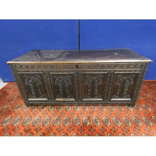 345 - 18th century carved oak coffer of large proportions with hinged top above three panels bearing allov... 