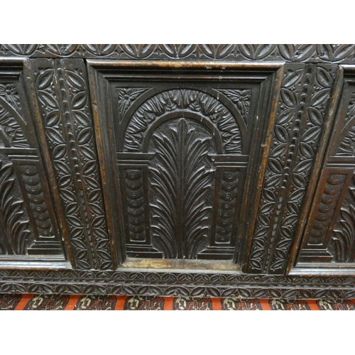 345 - 18th century carved oak coffer of large proportions with hinged top above three panels bearing allov... 