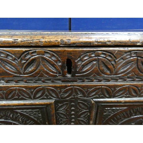 345 - 18th century carved oak coffer of large proportions with hinged top above three panels bearing allov... 