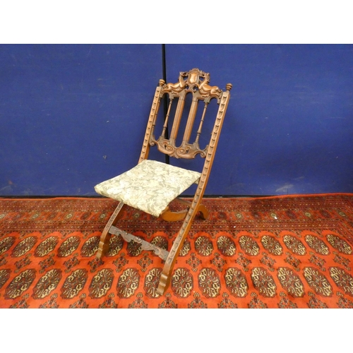 382 - Unusual 19th century oak folding chair with carved heraldic cresting.