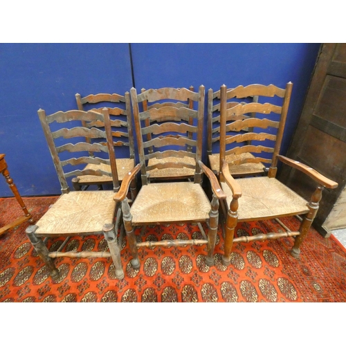 386 - Set of six elm ladderback chairs in Lancashire style with rush seats, including two with arms.