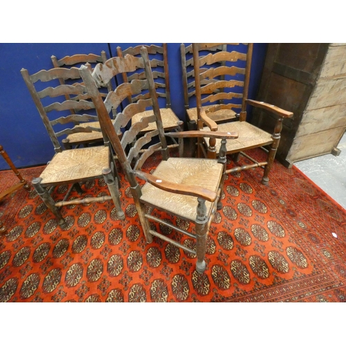 386 - Set of six elm ladderback chairs in Lancashire style with rush seats, including two with arms.