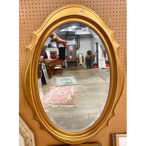 409 - Gilt framed oval wall mirror.93cm x 64cm.