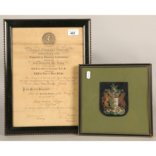 402 - Embroidered badge crest mounted in frame, and a certificate from the Royal Humane Society, Bronze Me... 