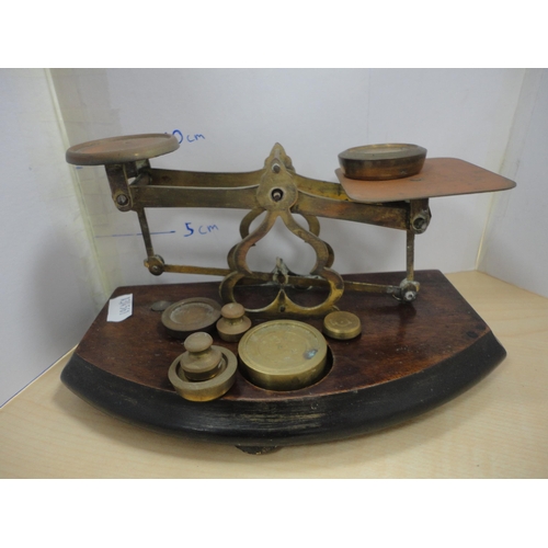 182 - Two sets of brass and oak postal scales with weights.
