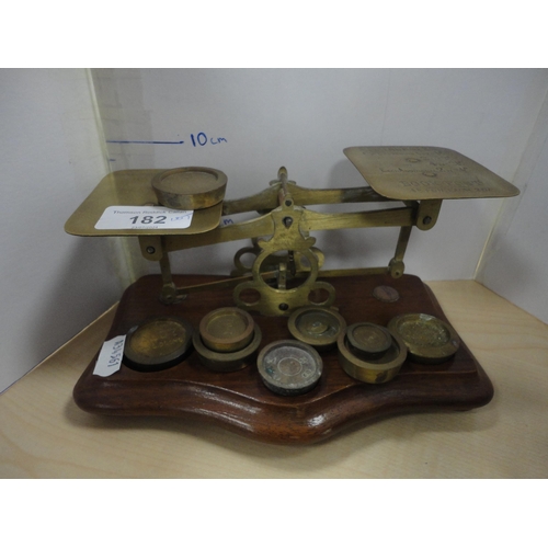 182 - Two sets of brass and oak postal scales with weights.