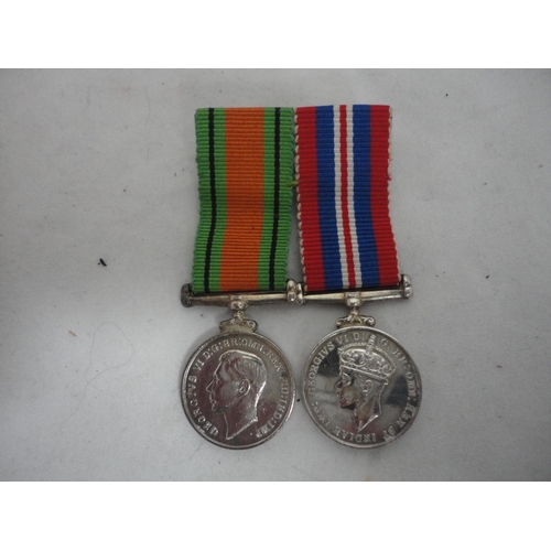 208 - Pair of WWII campaign medals with matching dress miniatures.