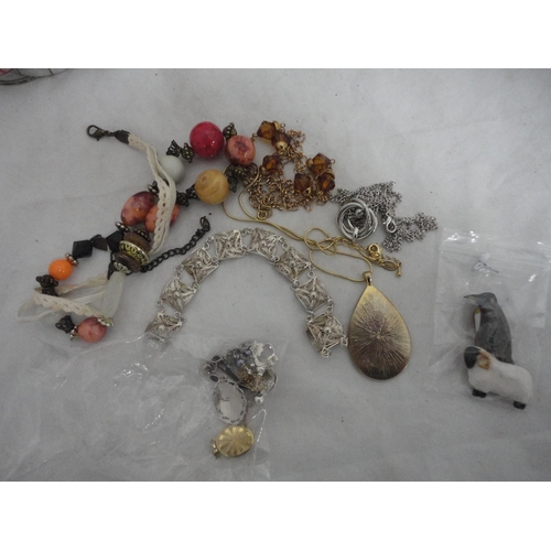 209 - Small tin containing miscellaneous costume jewellery to include bead necklaces, bangles, pendant etc... 