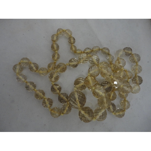 210 - Bag containing glass beads, silver brooch and a white metal Celtic-style brooch etc.