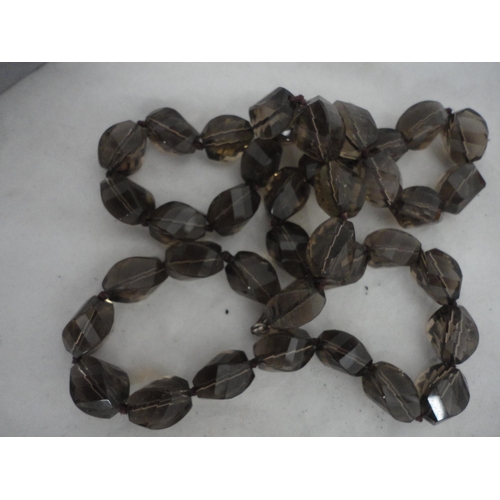 210 - Bag containing glass beads, silver brooch and a white metal Celtic-style brooch etc.