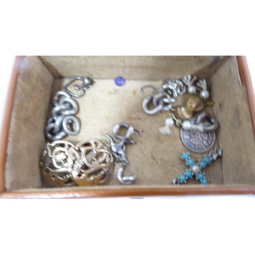 247 - Small leather case containing a silver threepence, earrings, kangaroo charm, pen knife, Japanese bur... 