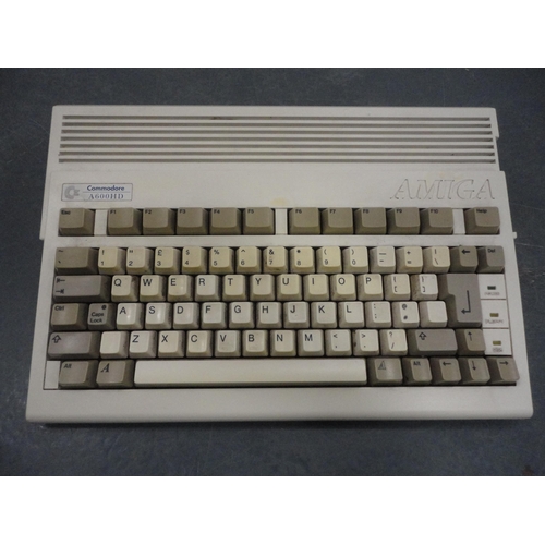 60 - Two Commodore Amiga A600 computers, mice, discs and accessories, also assorted Sega Megadrive games.