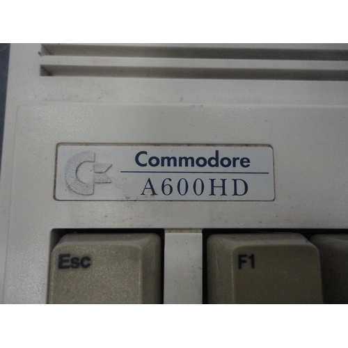 60 - Two Commodore Amiga A600 computers, mice, discs and accessories, also assorted Sega Megadrive games.
