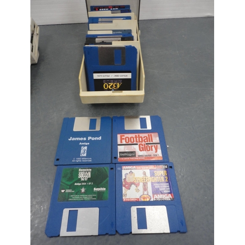 60 - Two Commodore Amiga A600 computers, mice, discs and accessories, also assorted Sega Megadrive games.