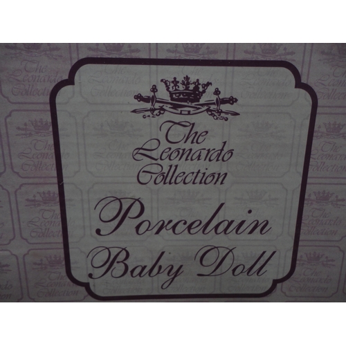 74 - Boxed Leonardo Collection porcelain dolls and teddy bears.