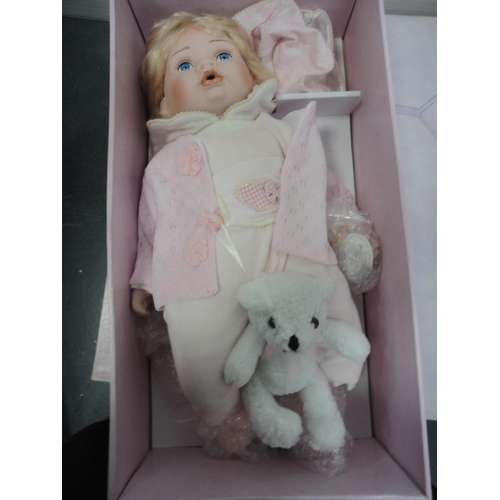 74 - Boxed Leonardo Collection porcelain dolls and teddy bears.