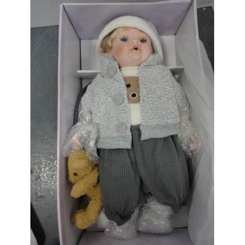 74 - Boxed Leonardo Collection porcelain dolls and teddy bears.