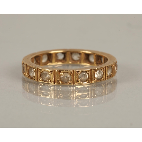 115 - Yellow metal eternity ring set with white gems