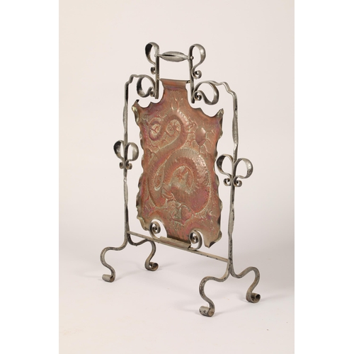 597 - Arts and crafts copper and wrought iron fire screen, with embossed coiled dragon decoration, 82cm hi... 